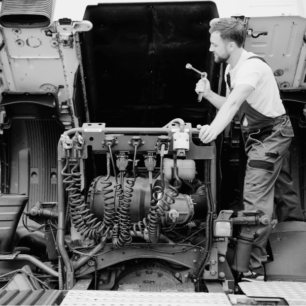 a mechanic repair a truck engine