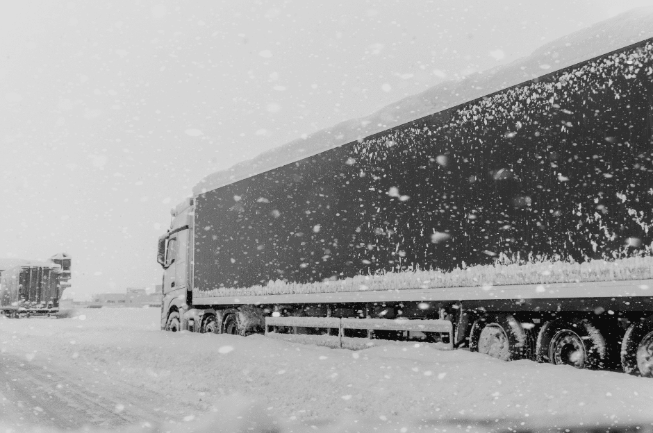 a semi truck driving in the snow