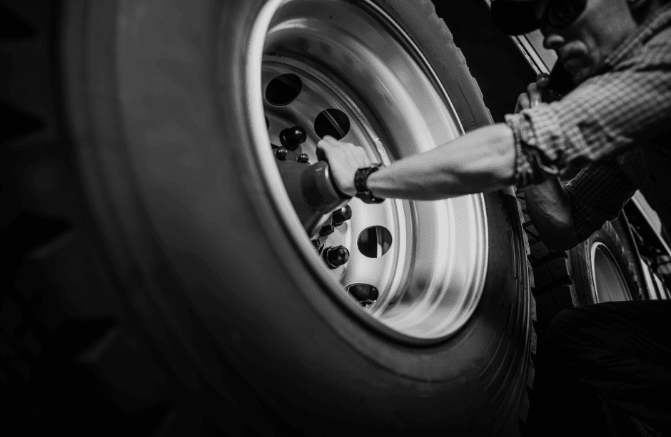 a mechanic working on a truck tire