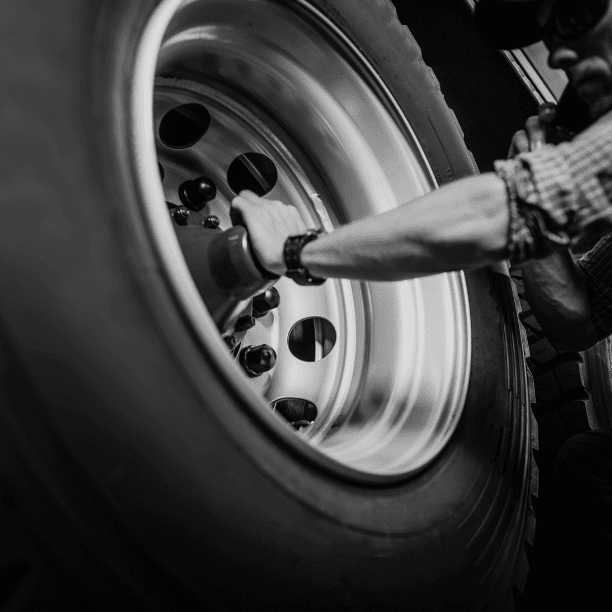 a mechanic repairing a truck tire